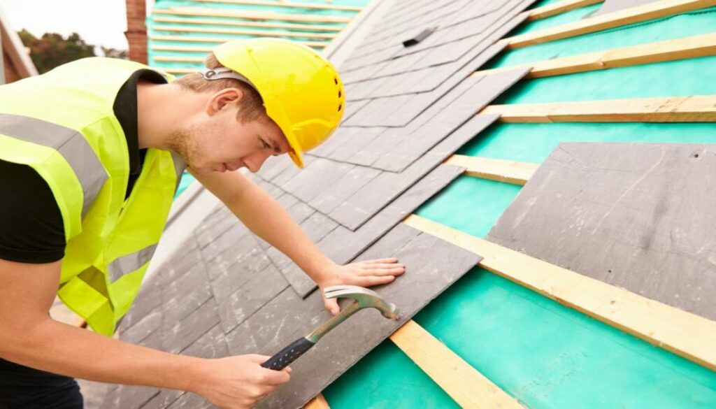 Worker assembling roof tiles