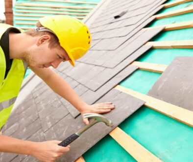 Worker assembling roof tiles