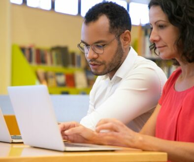 adults studying on laptops
