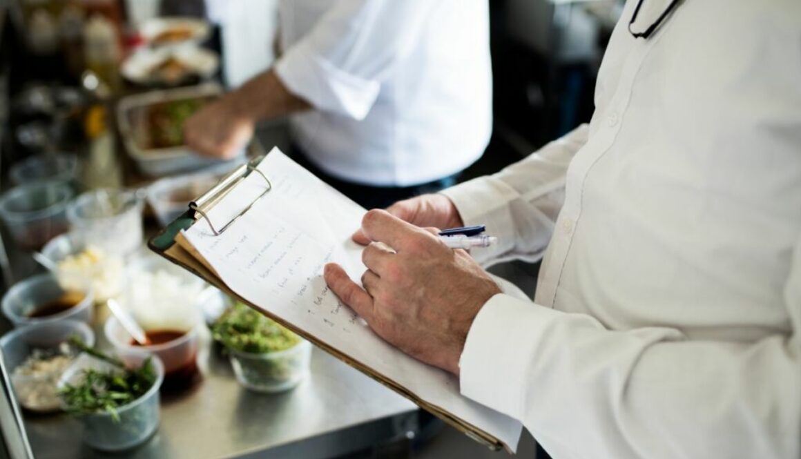 Closeup of chef hand checking menu list