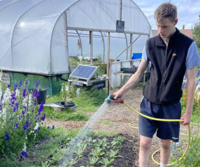 SBYG youth watering plants at farm