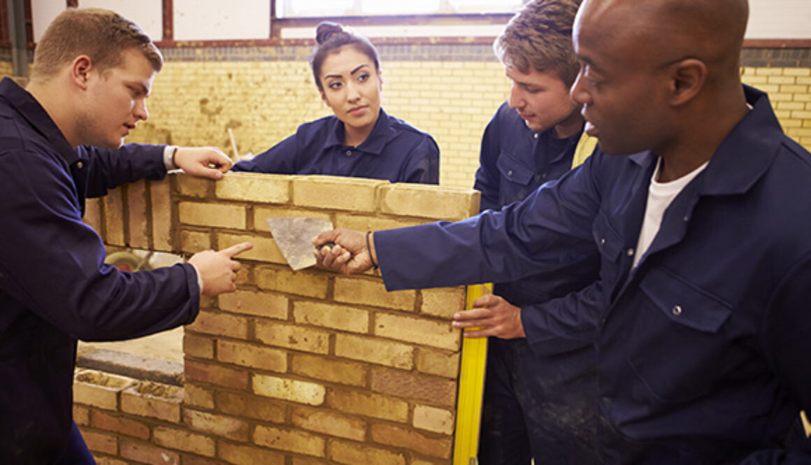 Apprentices learning brick laying