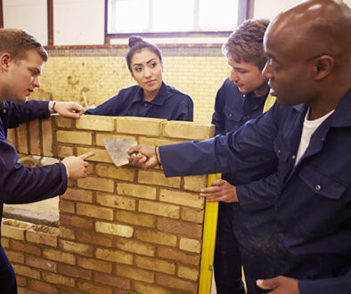 Apprentices learning brick laying